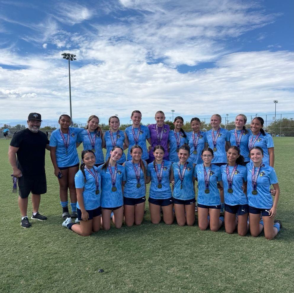 Storm girls team with medals and coach
