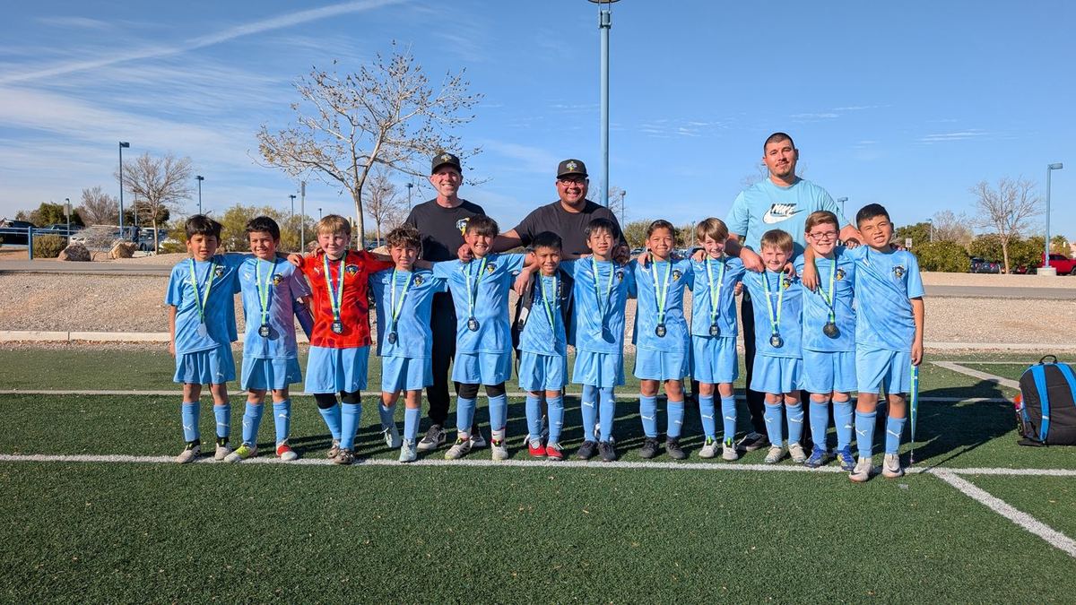 Storm boys team lineup with medals and coaches